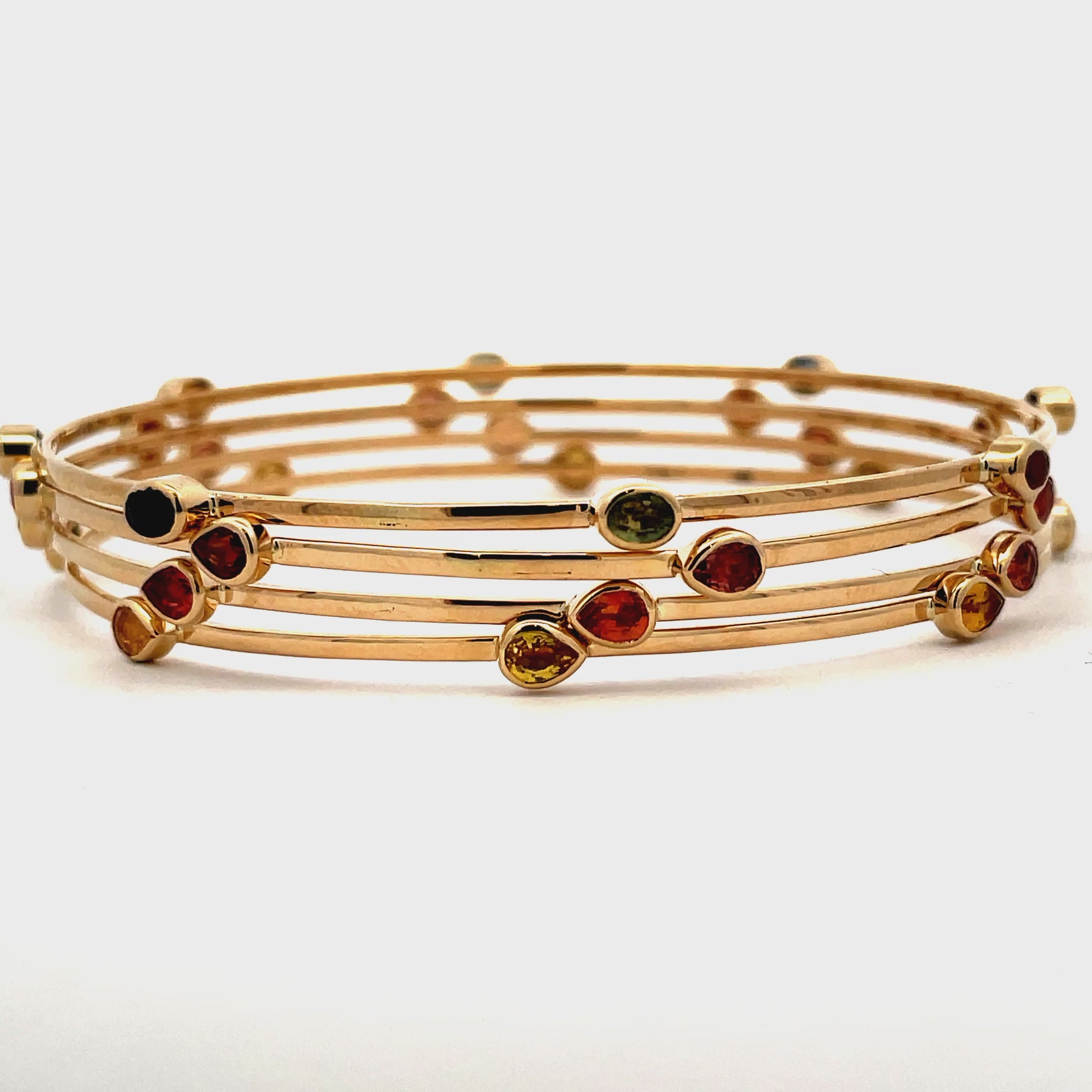 Try on video of 14k Yellow Gold Multicolor Sapphire Bangles