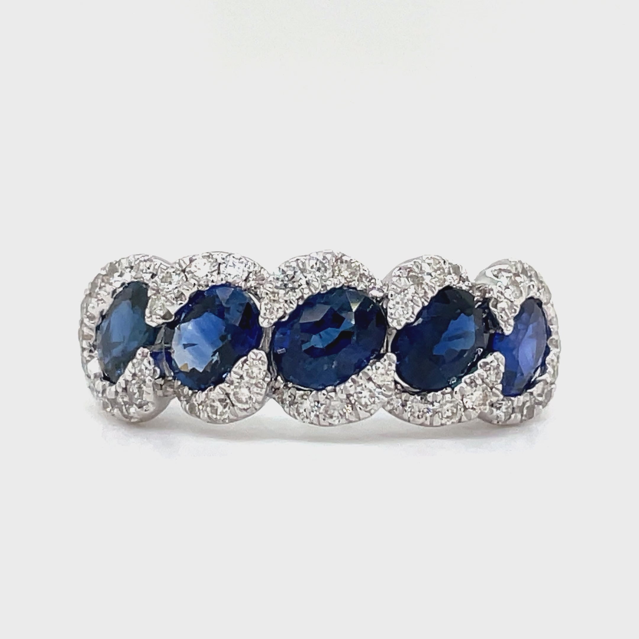 his 18k white gold ring features five stunning oval sapphires, totaling 2.32 carats, and sparkling round diamonds with a total weight of 0.43 carats. The perfect combination of elegance and femininity, this ring is sure to make a statement.