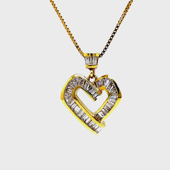 ndulge in luxury with this 18K yellow gold heart pendant necklace adorned with 2.00 carats of sparkling baguette cut diamonds. The diamonds are expertly channel set, adding to the sophistication and elegance of this piece. Complete your look with the included 18" yellow gold chain.