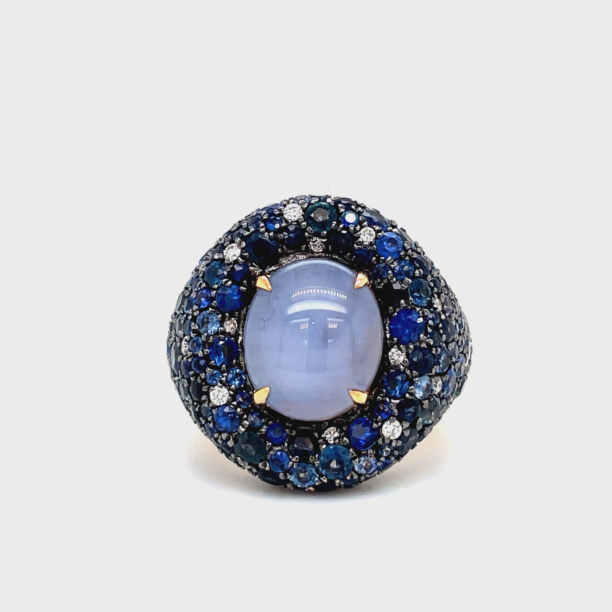 Experience the timeless elegance of our Unique Style Sapphire Cabochon, Faceted Sapphire &amp; Diamond Dome ring. The light blue sapphire cabochon (5.96 cts) and blue faceted sapphires (5.00 cts) exude sophistication, while the sparkling round diamonds (0.21 cts) add a touch of luxury. Crafted in 18k rose gold, this piece is a true work of art.