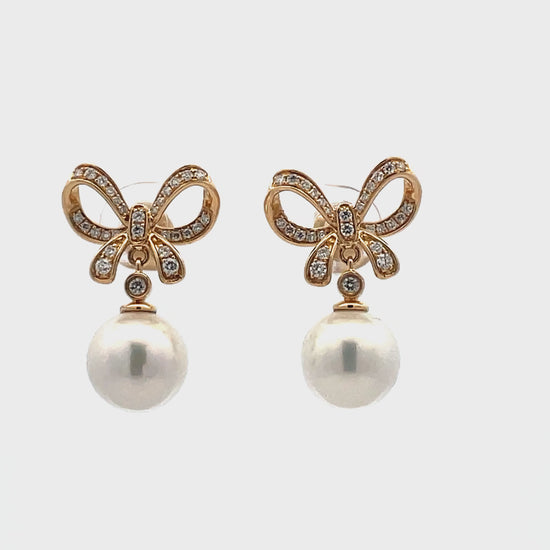 Try on video of 14k Yellow Gold Diamond Bow Drop Pearl Earrings