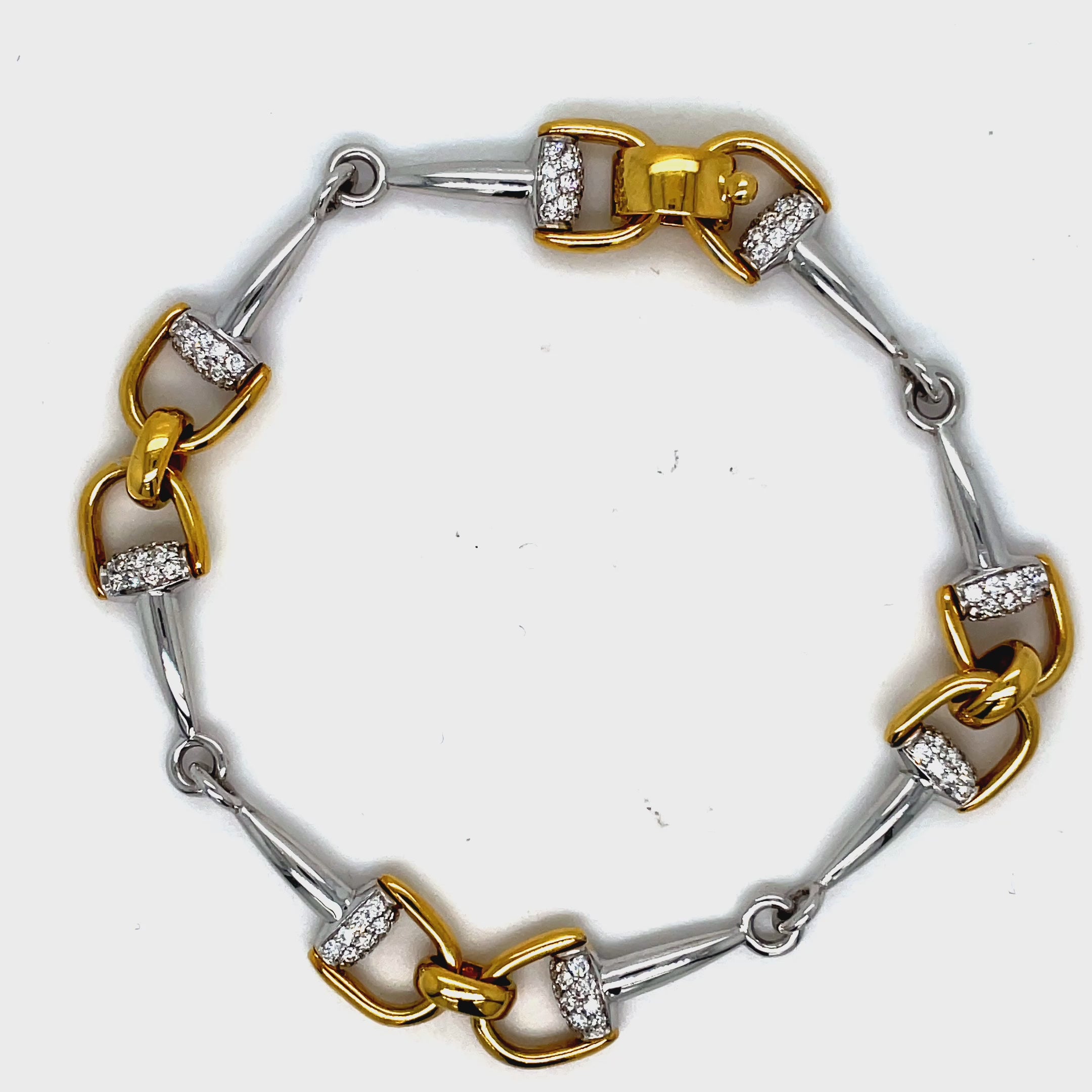 Indulge in luxury with our 18k Italian Yellow Gold Horse Bit Link Bracelet! Made in Italy, this everyday accessory is perfect for easy stacking and adds a touch of elegance to any outfit. Set in a flawless 18k yellow gold mounting and round diamonds 1.15 cts with secure clasp. Its versatile 7-inch length with sizing loops ensures the perfect fit. Elevate your jewelry collection with this exquisite piece!"