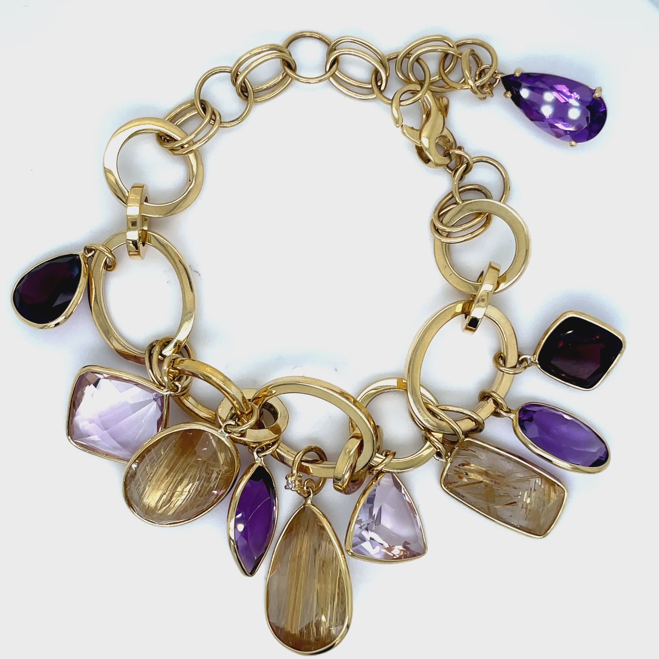 Experience the allure of luxury with our Pink Amethyst, Amethyst &amp; Citrine Bracelet. Made in Brazil with rare, unique cut stones of pink amethyst, amethyst, and citrine, set in 18k yellow gold. The large open links and secure lobster clasp add a touch of sophistication to any outfit. Elevate your style with this exclusive piece.