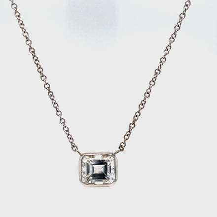 This exquisite pendant necklace features an emerald cut diamond weighing 1.19 carats with a color grade of E and clarity grade of VVS2, set in a 14k white gold pendant. The 18" long chain completes the elegant look. Enhance any outfit with this stunning piece of timeless jewelry.