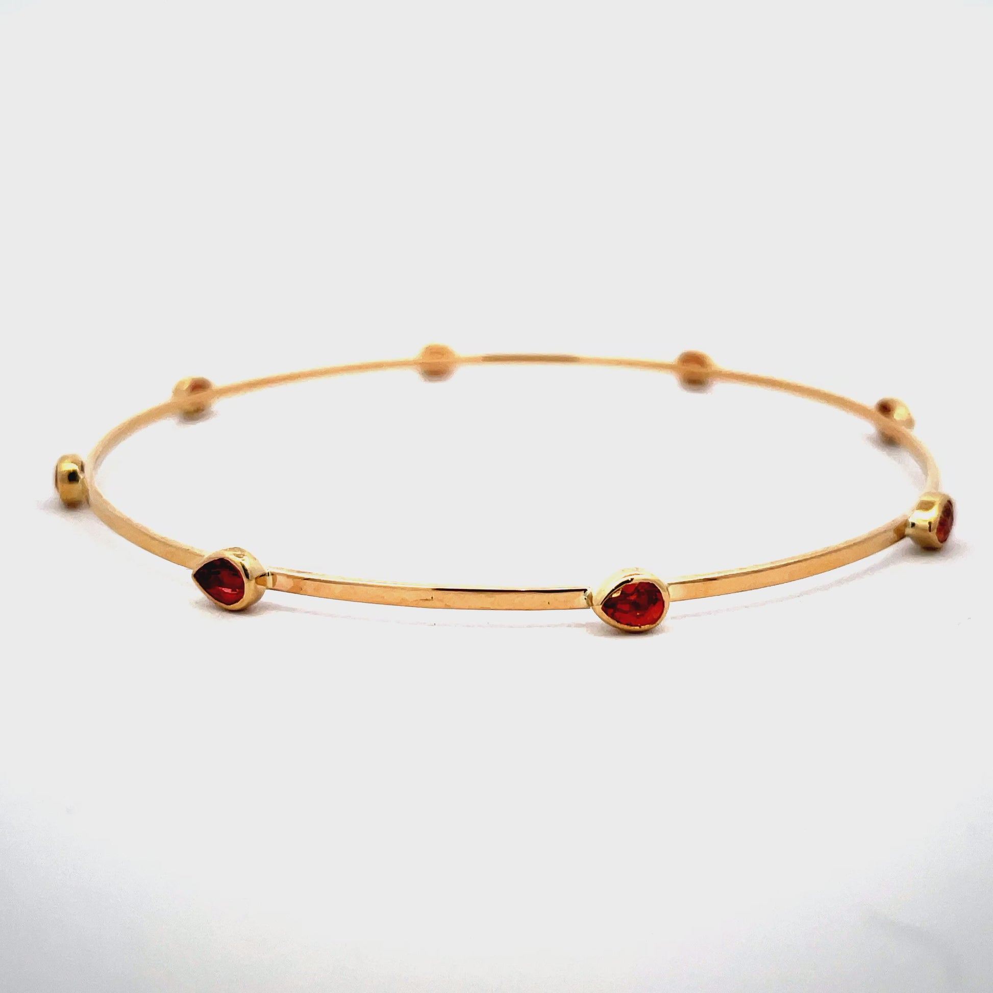 Try on view of 14k Yellow Gold Orange Sapphire Bangle 