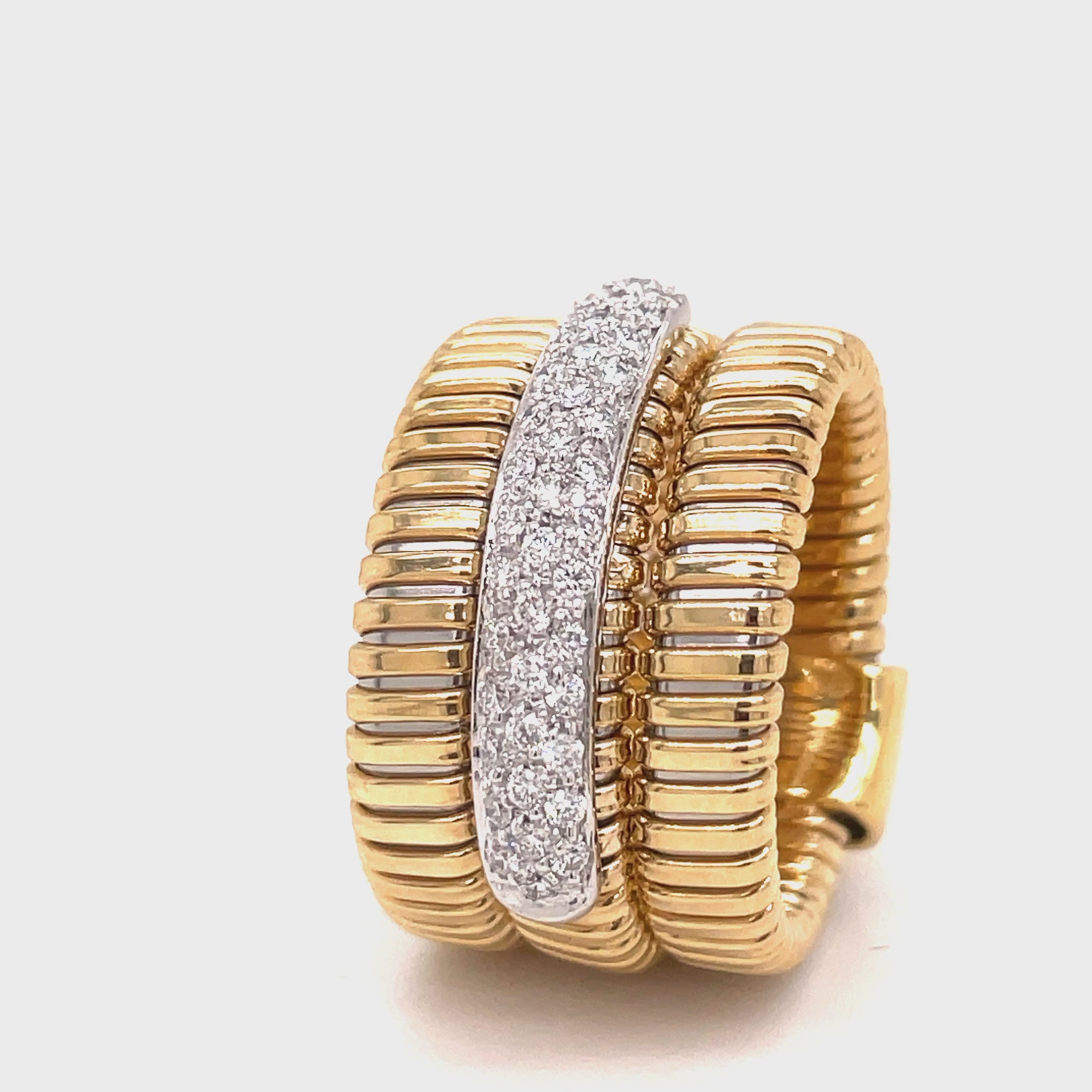 Indulge in luxury with the Italian Gold &amp; Diamond Three Row Flexible Ring. From the exquisite Italian designer Novecentonovantanove, this ring features an innovated tubogas technique that allows for flexibility and comfort. With a classic and contemporary design, this 15.00 mm wide ring boasts three rows of round diamonds totaling 0.40 carats. Available in size 6.5 and sizeable for the perfect fit. Elevate your style with this sophisticated and exclusive piece.