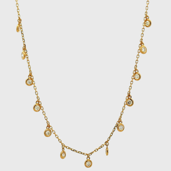 Try on video of 14k Yellow Gold Bezel-Set Diamond Drop Charm Necklace