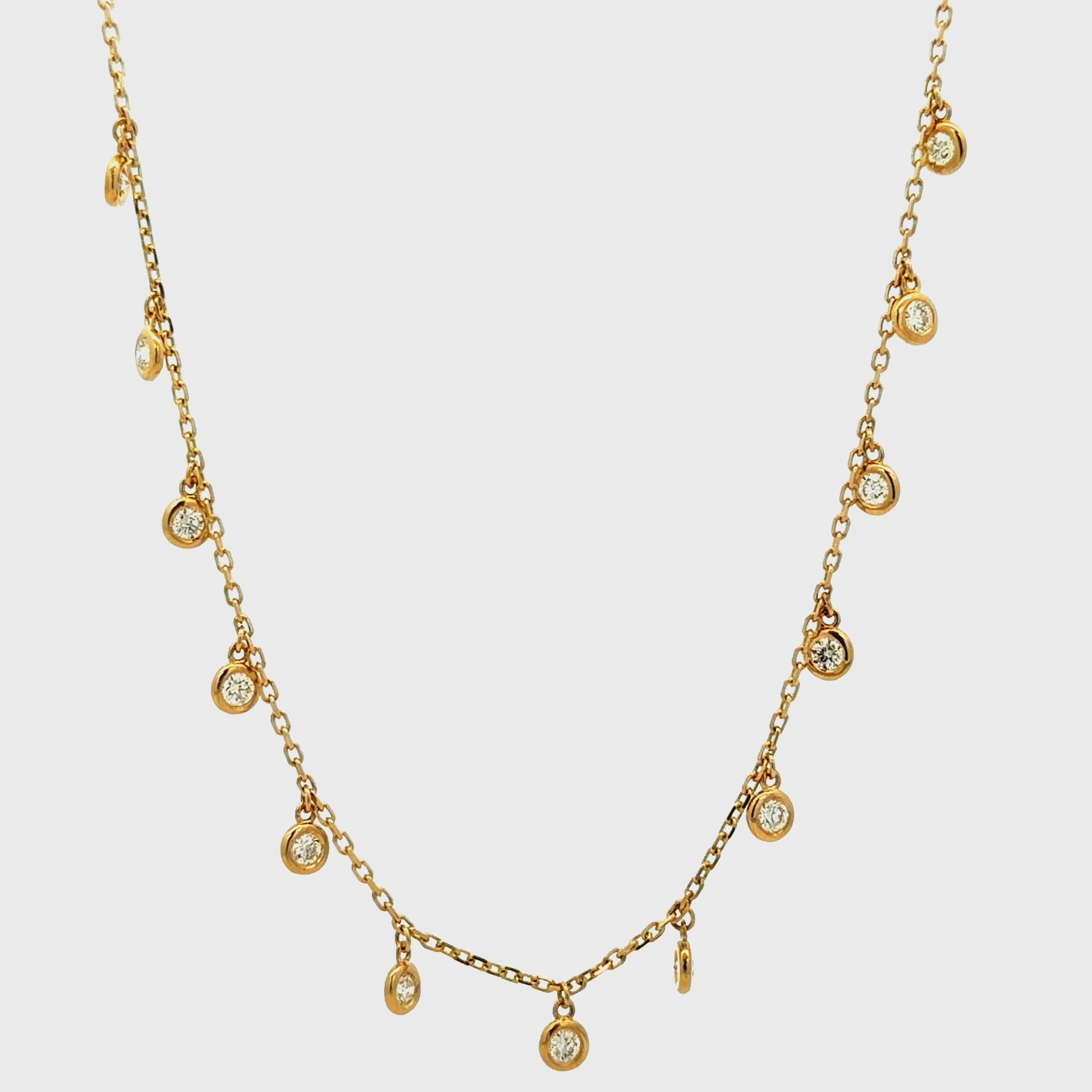 Try on video of 14k Yellow Gold Bezel-Set Diamond Drop Charm Necklace
