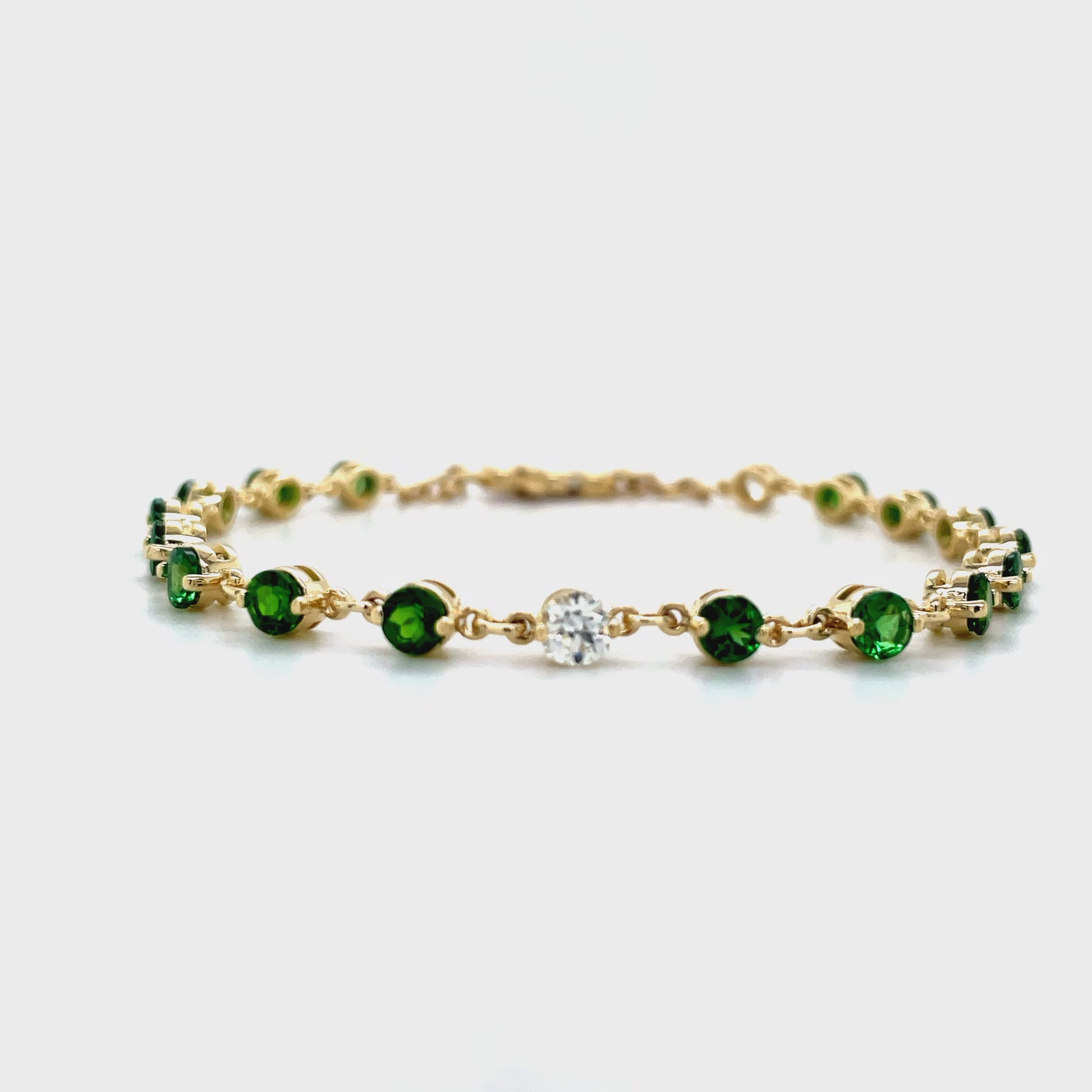 ndulge in the opulence of our Tsavorite &amp; Diamond Bezel Bracelet. Crafted from 14k yellow gold, it boasts 16 round tsavorite gems and two round diamonds, each individually bezel set for maximum elegance. Elevate any outfit with this luxurious piece, a must-have for any modern-day sophisticate.