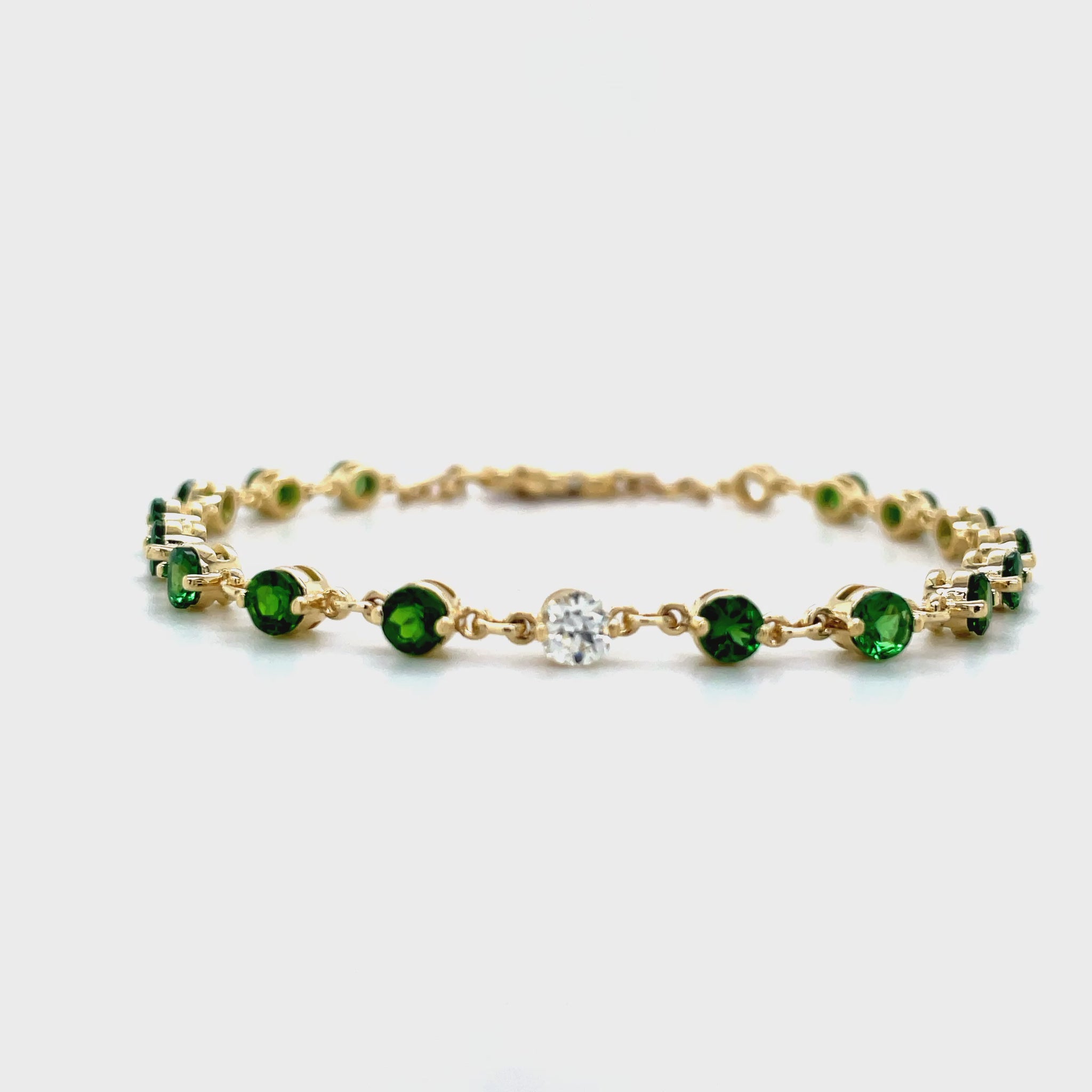 ndulge in the opulence of our Tsavorite &amp; Diamond Bezel Bracelet. Crafted from 14k yellow gold, it boasts 16 round tsavorite gems and two round diamonds, each individually bezel set for maximum elegance. Elevate any outfit with this luxurious piece, a must-have for any modern-day sophisticate.