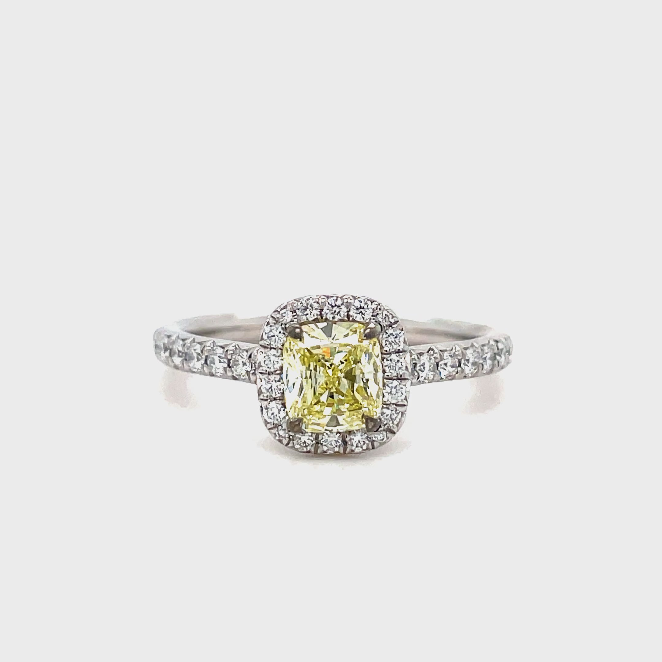 ntroducing our exquisite Estate Tiffany and Co. Fancy Yellow Diamond and Round Diamond Engagement Ring. Crafted with platinum and boasting a stunning 0.72 ct fancy yellow diamond with VS1 clarity, this ring exudes elegance and sophistication. Surrounded by 0.70 cts of sparkling round diamonds, it is a true masterpiece that will captivate any admirer. Elevate your love with this luxurious and exclusive piece.