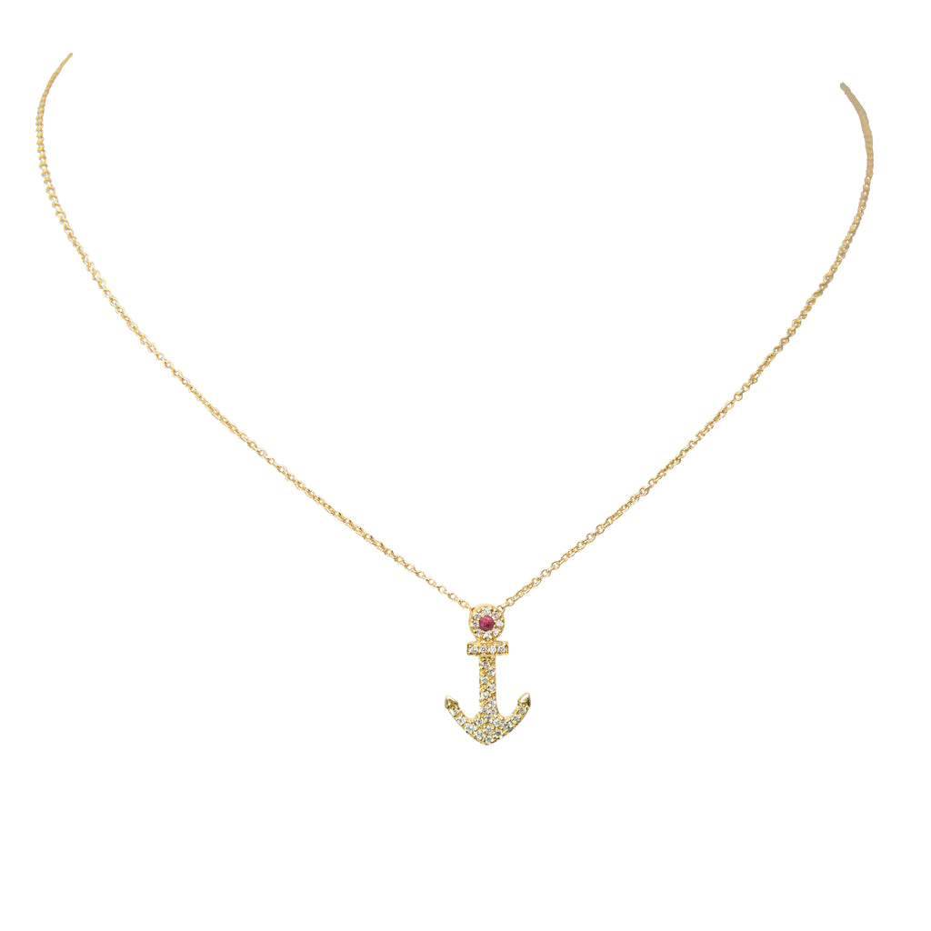 Gleaming 18K yellow gold encases a diamond-studded, ruby-adorned anchor pendant, suspended by a secure 16" yellow gold chain. 0.12cts of diamond and one small ruby sparkle within the intricately-crafted bail, creating a stunning addition to any look.