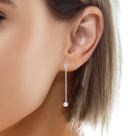 These diamonds float and dance, captivating in their intricate motion. Crafted in shimmering 18k white gold, they hold 0.34 cts of brilliant round diamonds. Held securely by a secure friction back, these earrings reach a length of 1.5" and are the perfect adornment for any occasion.