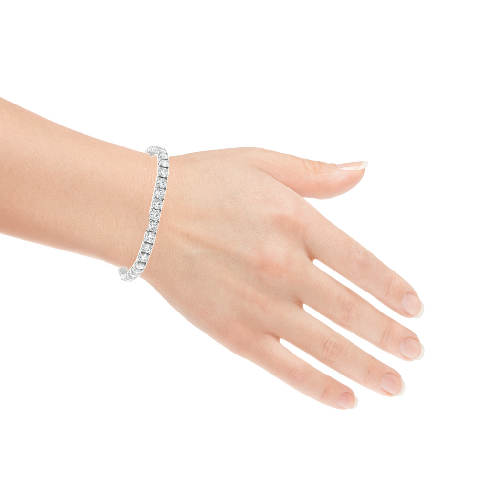 Gleaming 5.00 cts of E/F colored diamonds, with VS-1 clarity, are prong set in 14k white gold to craft this 7" long, dazzling diamond line tennis bracelet.