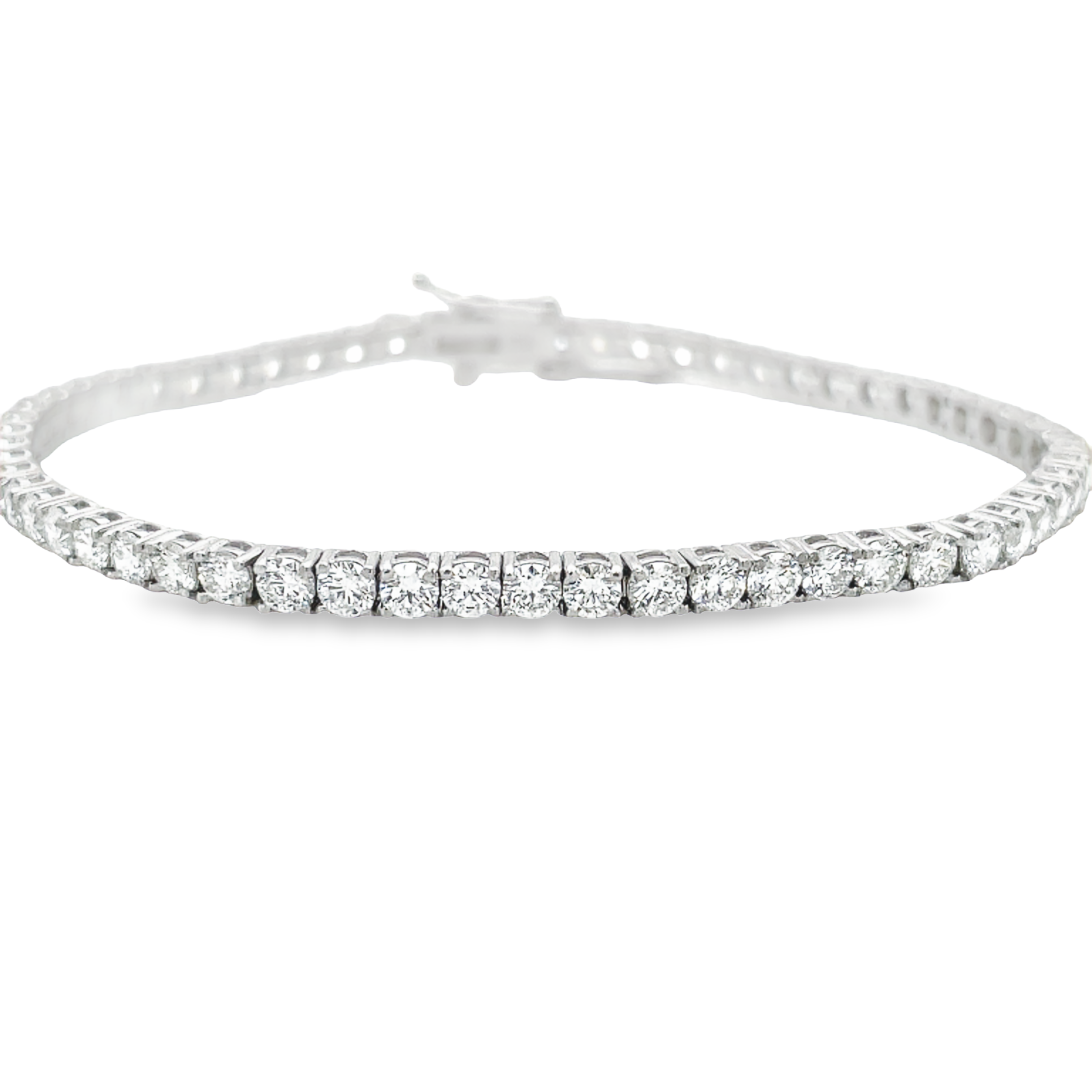 Gleaming 5.00 cts of E/F colored diamonds, with VS-1 clarity, are prong set in 14k white gold to craft this 7" long, dazzling diamond line tennis bracelet.