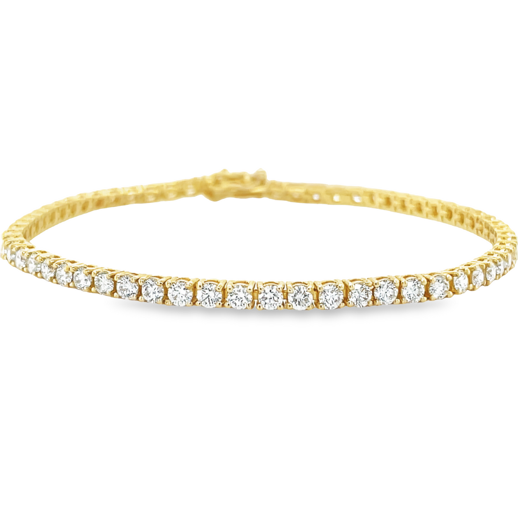 Exquisite 4.40 ct round diamonds, F/G color, VS1 clarity, set in 14k yellow with 7" length. This gorgeous line bracelet is prong set and securely fastened with a hidden clasp and two figure 8 safety clasps for your assurance. 