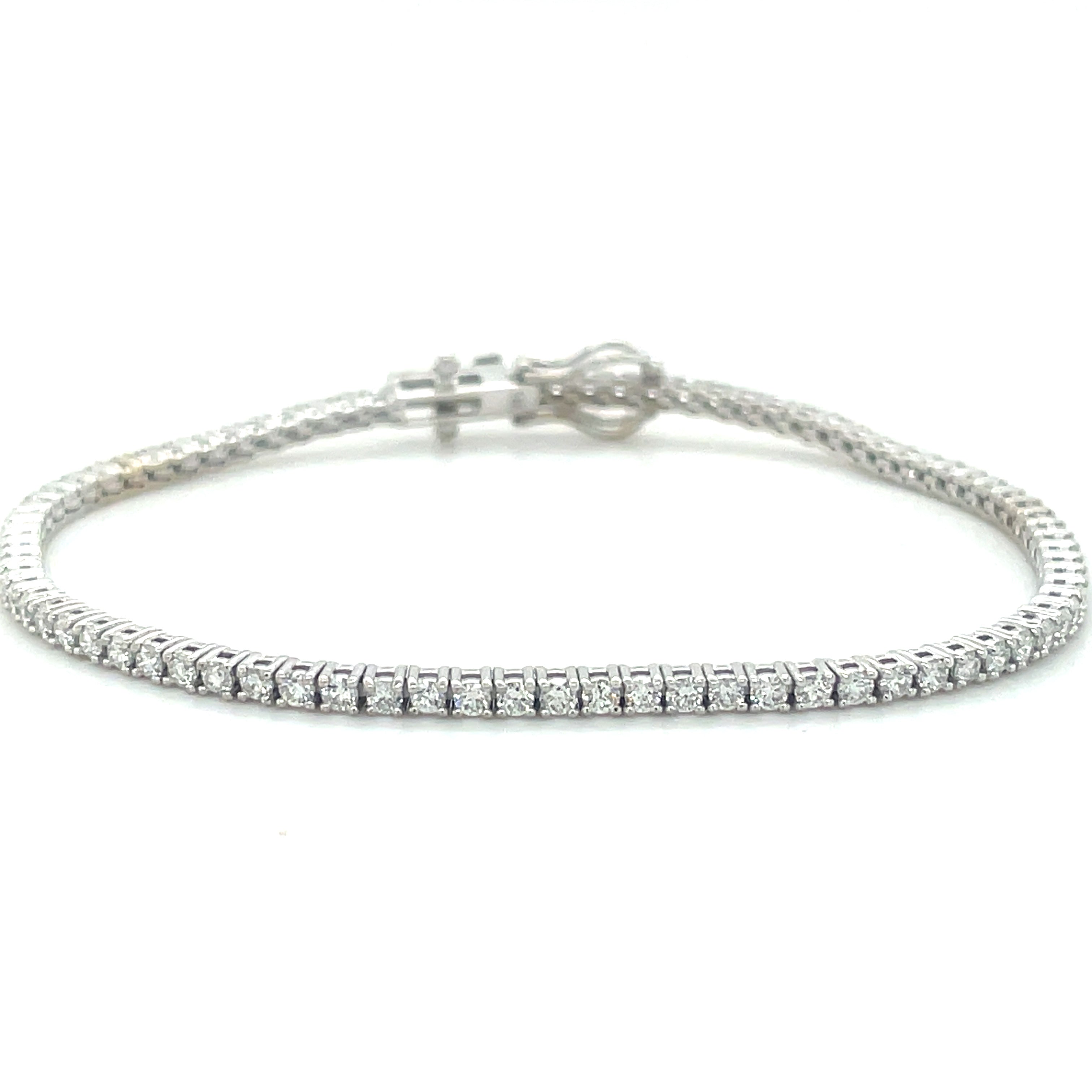 ndulge in luxury with our Diamond Line Tennis Bracelet featuring 2.25 cts of sparkling round cut diamonds in classic H color and SI1 clarity. Each diamond is prong-set in elegant 14kt white gold, forming a stunning 7" line bracelet for the sophisticated woman. Step out in style with this timeless accessory.