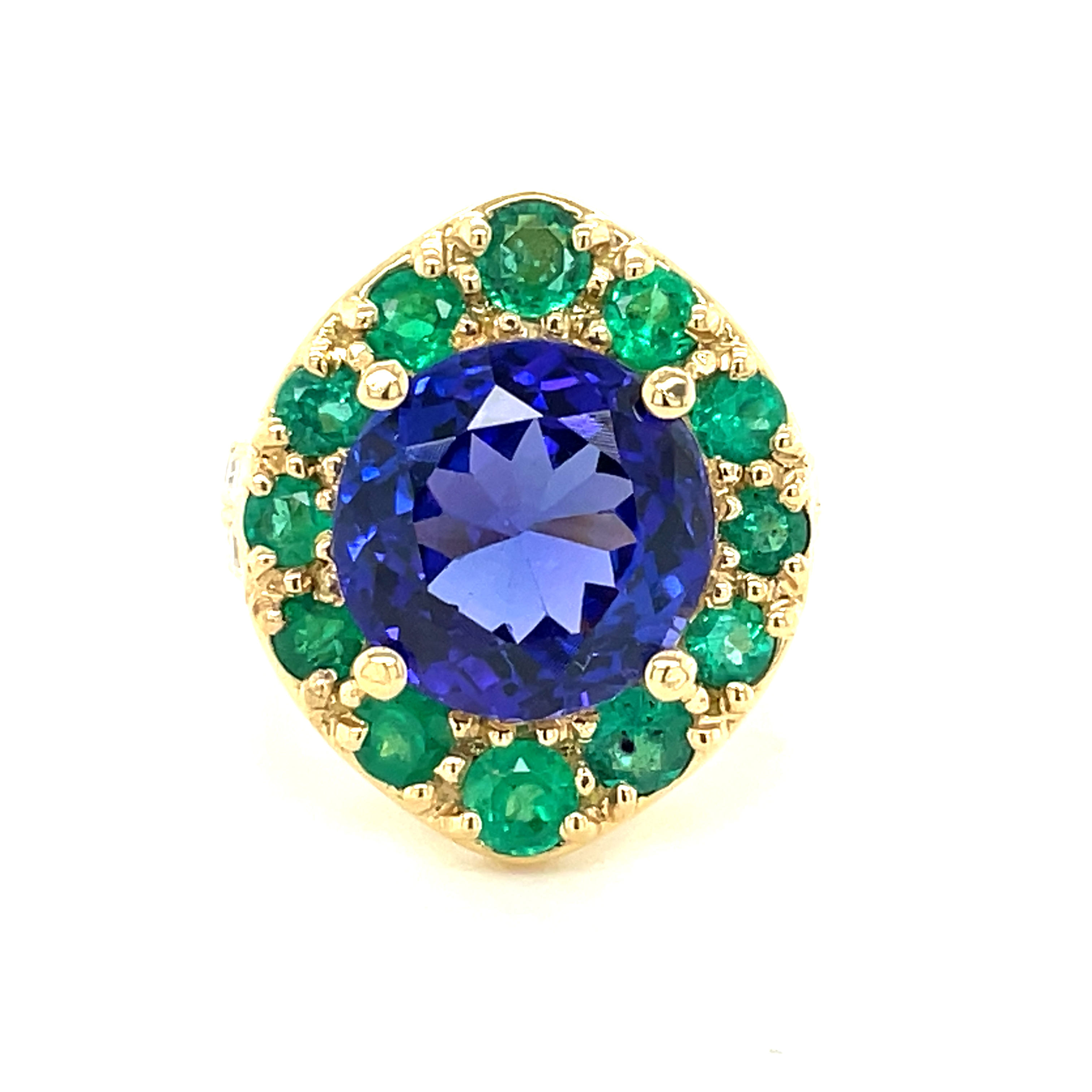 One of a kind ring custom made for our 40th anniversary.  This ring is to resemble the peacock color of our store logo.  Great quality round Tanzanite 7.42 cts  Embellish with round Colombian emeralds 1.40 cts  Round diamonds set in double band 1.30 cts   Set in a high large basket  23.00 x 20.00 mm   Size 6.5 (sizeable)
