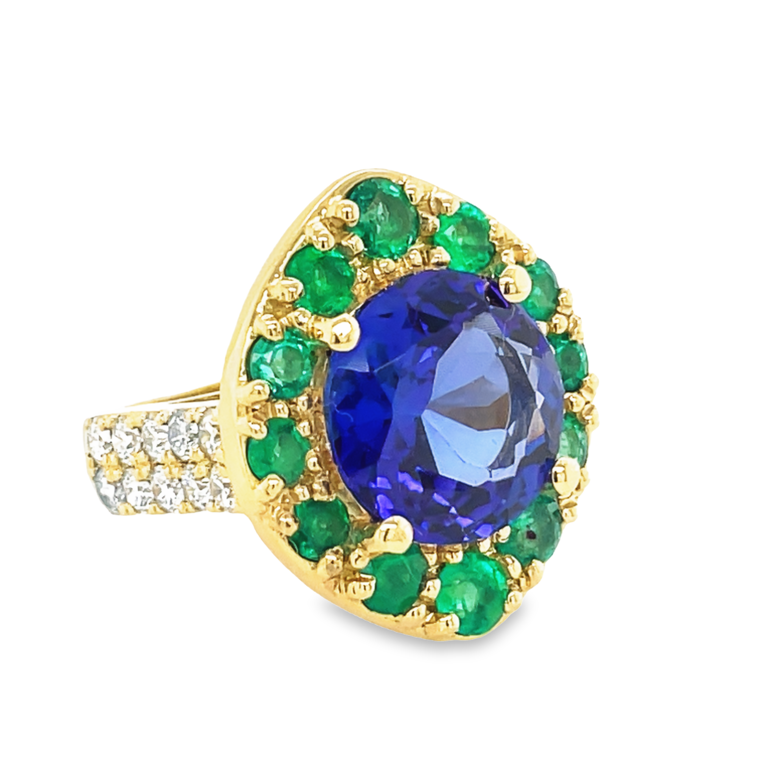 One of a kind ring custom made for our 40th anniversary.  This ring is to resemble the peacock color of our store logo.  Great quality round Tanzanite 7.42 cts  Embellish with round Colombian emeralds 1.40 cts  Round diamonds set in double band 1.30 cts   Set in a high large basket  23.00 x 20.00 mm   Size 6.5 (sizeable)