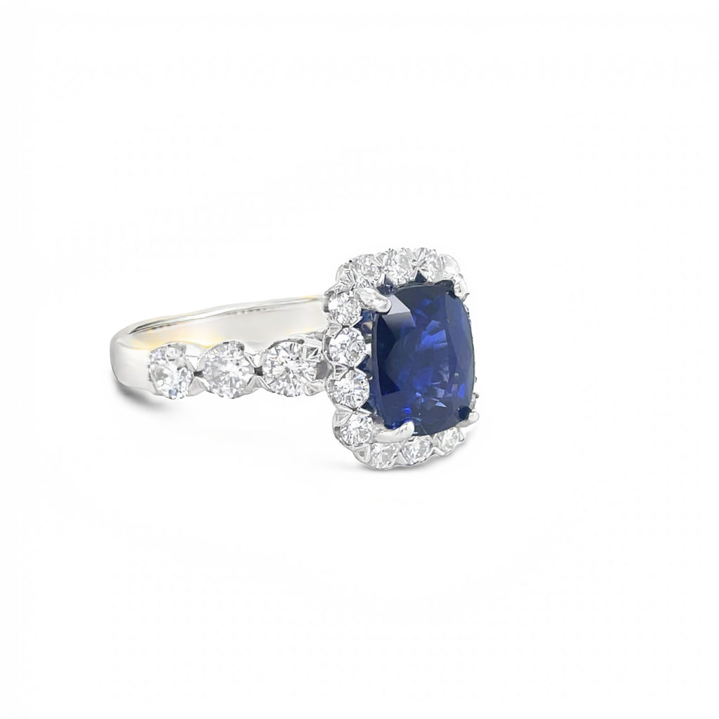 A stunning cushion-cut 2.22 ct sapphire is the centerpiece of this luxurious piece, accompanied by 1.09 ct round diamonds bezel-set in 18k white gold. It's an unforgettable ring. Size 6.5 (resizable).
