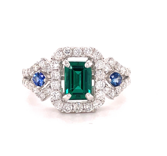 Front view of 18k White Gold Emerald Cut emerald with Diamond Halo & Sapphire Ring