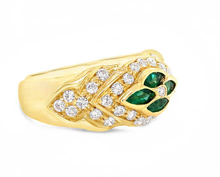 18k yellow gold  Surrounded by white round diamonds    Four marquise emeralds   9.50 mm.