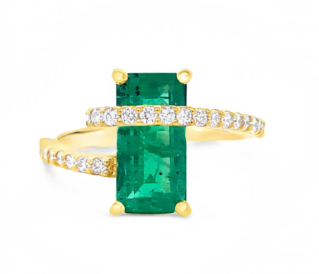 Unique & modern style  Emerald cut center stone 2.80 cts  Round diamonds 0.60 cts  Set in 18 yellow gold mounting  Four prong setting 