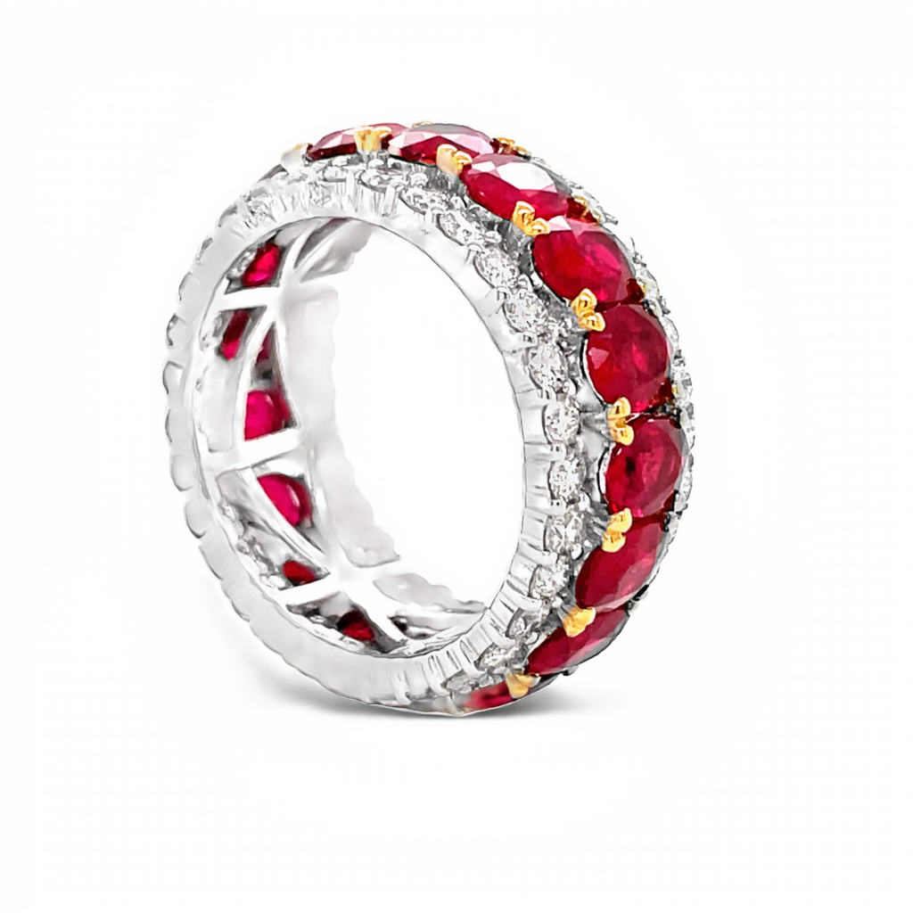 18k white & yellow gold ring  Oval shape Rubies 6.11 cts  Round diamonds 1.89 cts.  Eternity band   9.00 mm.  Size 6