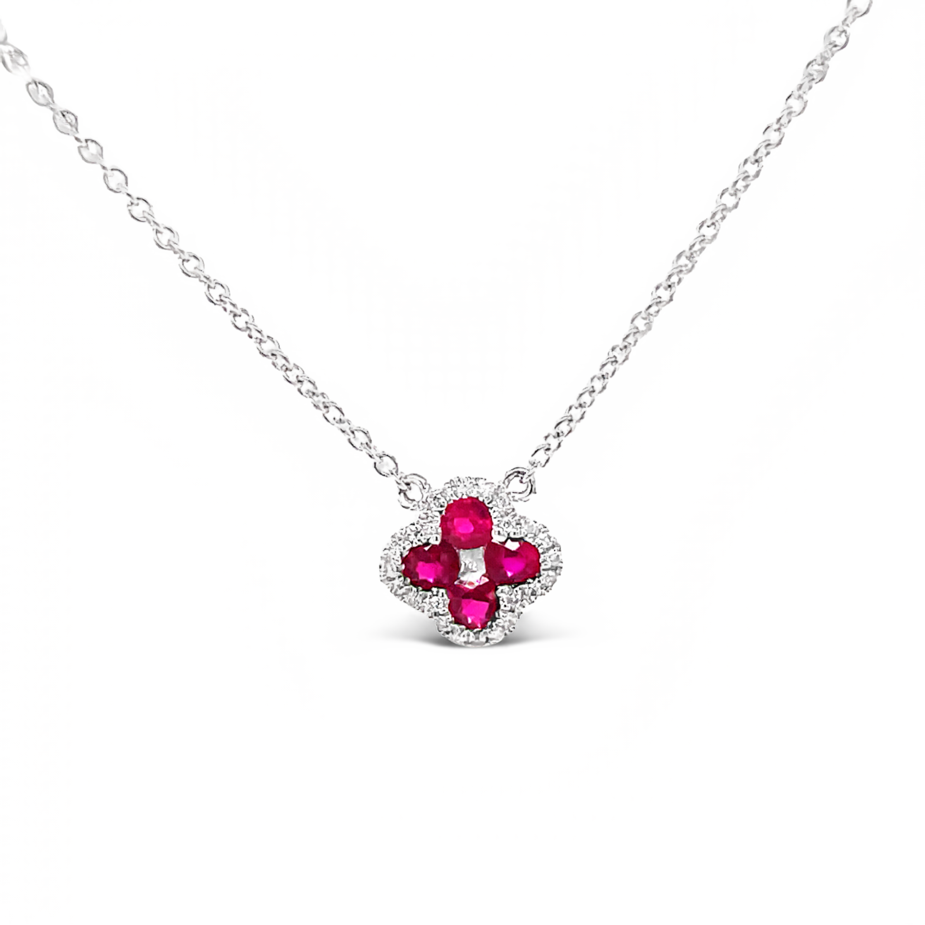 Diamond clover necklace 0.10 cts  Round rubies 0.25 cts   Color F/G  Clarity VS1  Set in 18 white gold   17" long with sizable loop at 16"  8.00 mm 