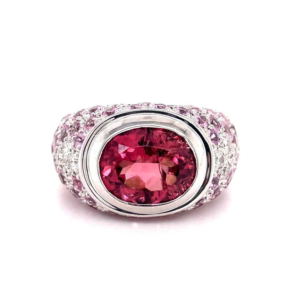 Italian made  Bezel set  18k white & yellow gold  7.0 size (sizable)  Large topaz oval 5.50 cts  Round diamonds 0.33 cts  Pink sapphires 3.80 cts   Gallery finish in the inside