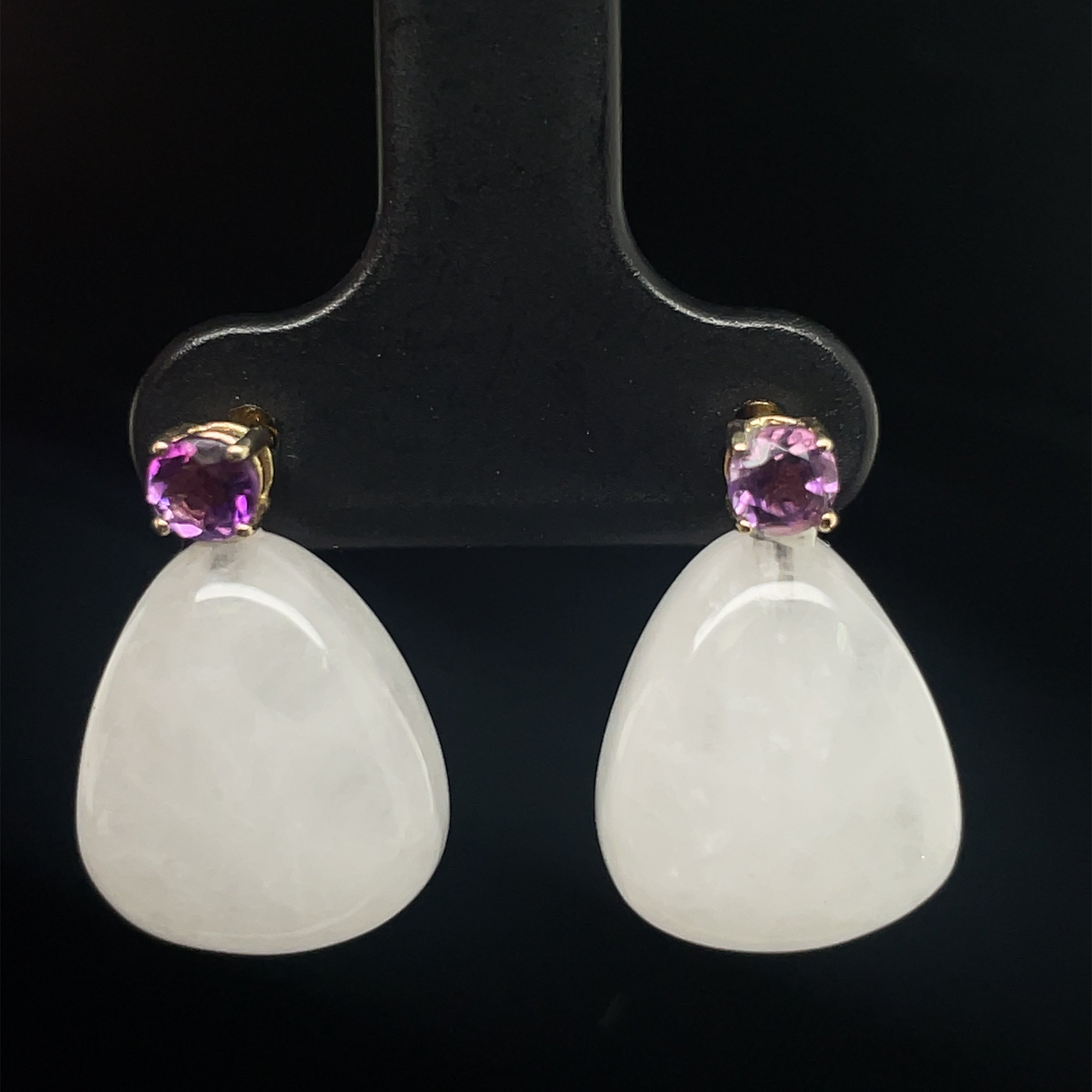Crafted in 14k yellow gold, these elegant earrings are accented with a pear shape agate cabochon and an amethyst cabochon, measuring 18 x 12 mm and secured with friction backs. 18x12 mm.