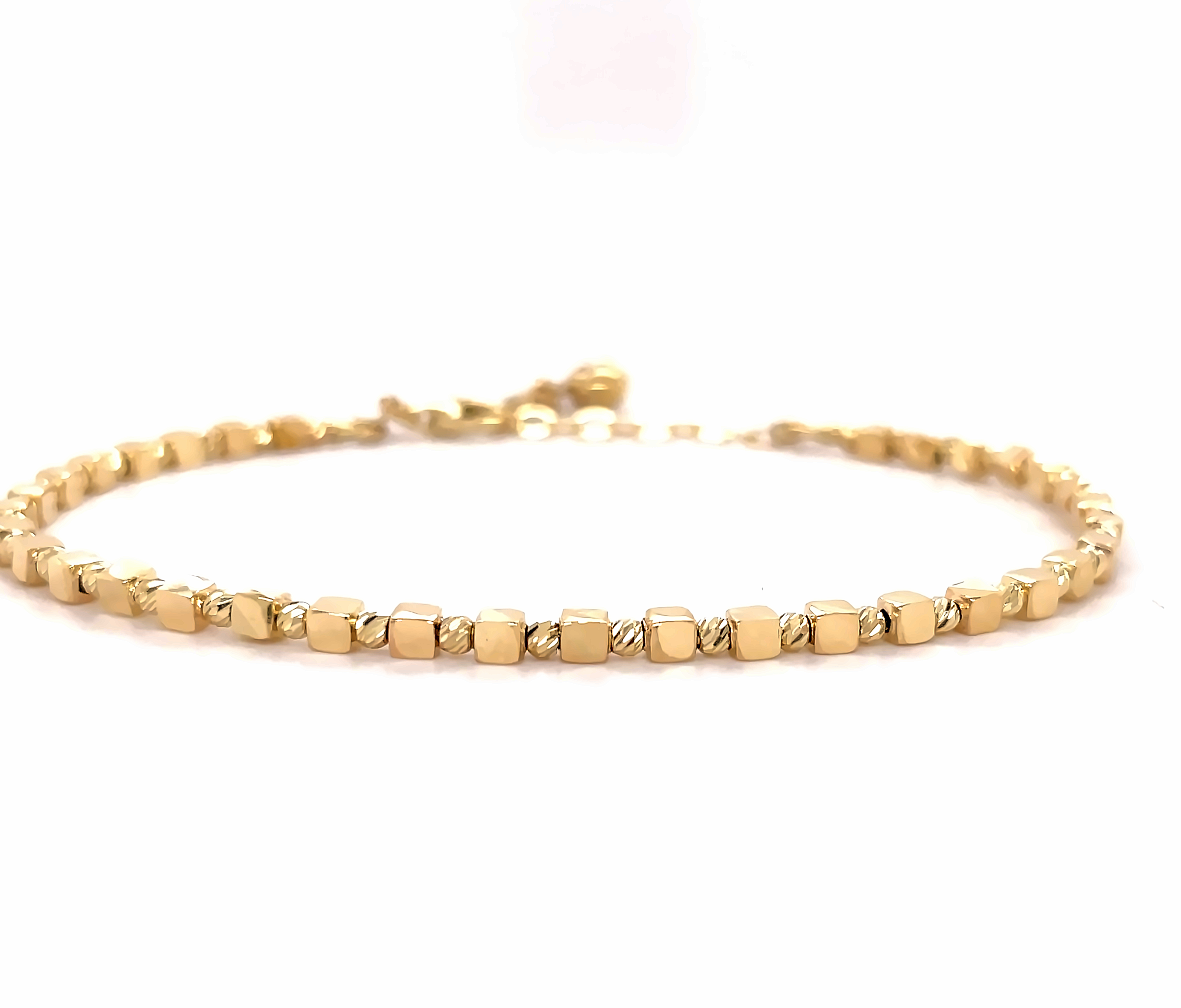 This 14k yellow gold bracelet is designed to be both stylish and secure. The 8 inch stackable bracelet features square beads and laser cut round beads for a truly unique look. The lobster clasp ensures it will stay securely in place.