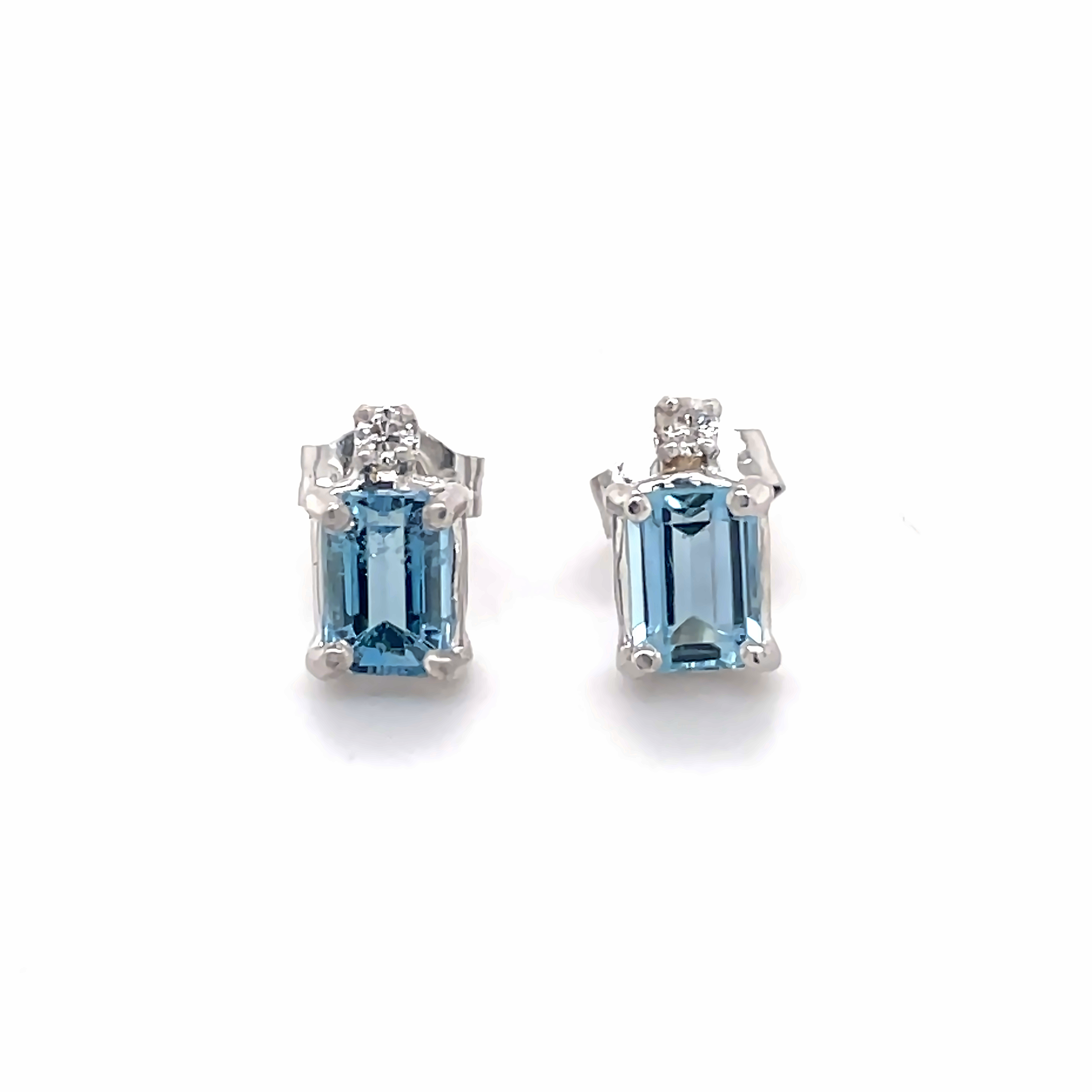 These timeless earrings feature two subtle Aquamarine stones and two glittering diamonds nestled in a refined 14k white gold setting with secure friction backs. A stunning testament to classic elegance.
