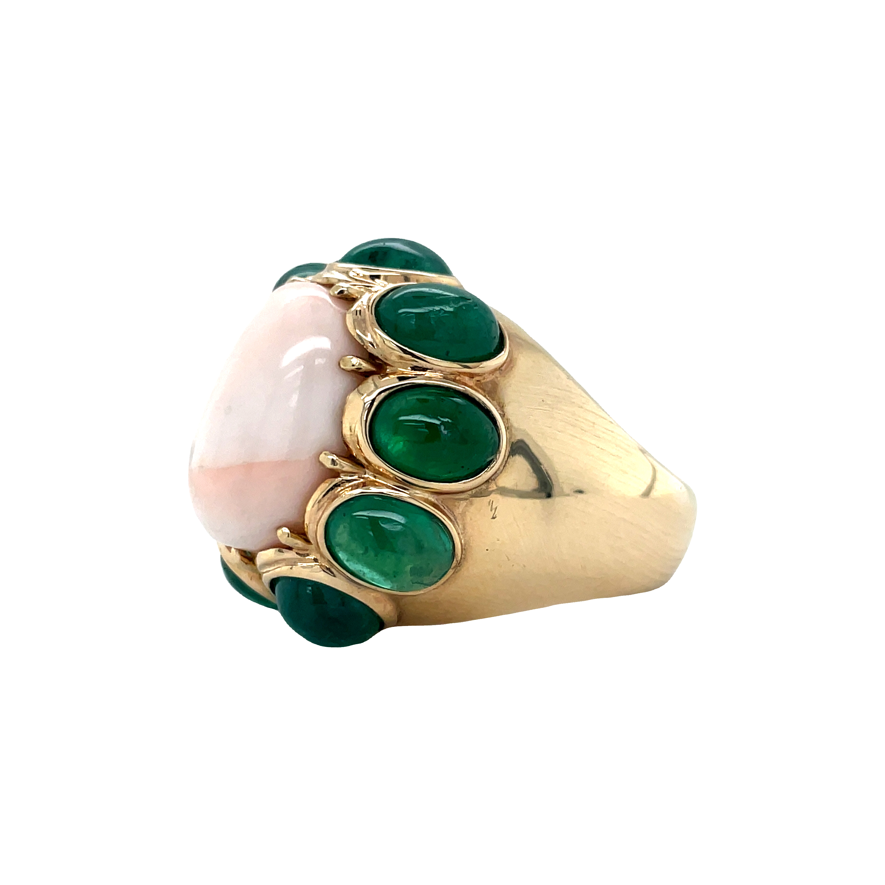 This 14k yellow gold antique ring is a stunning example of estate jewelry, with an angel skin coral cabochon measuring 23.00 mm surrounded by nine large emerald cabochons. Its great condition will make it a timeless piece you can treasure for years to come.