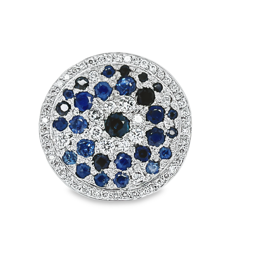 Round solid gold disk   Multi shade blue sapphires 1.20 cts  Round diamonds 0.25 cts,  Set in 18k white gold mounting  Size 7.5 (sizeable)  Double shank