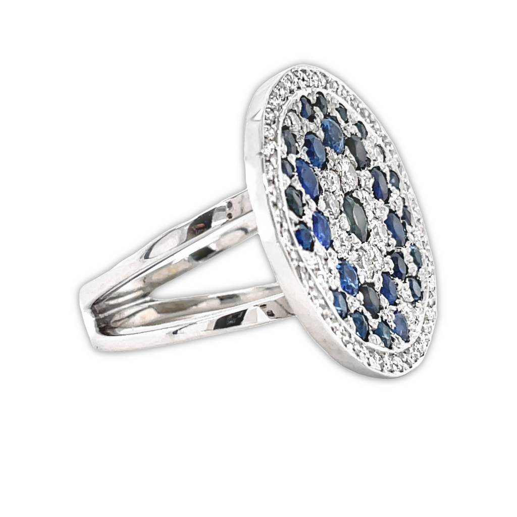Round solid gold disk   Multi shade blue sapphires 1.20 cts  Round diamonds 0.25 cts,  Set in 18k white gold mounting  Size 7.5 (sizeable)  Double shank