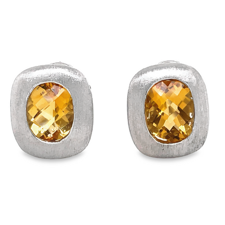 Oval-cut citrine gems are securely bezel-set in 14k white gold with omega back clips and feature a matte finish at 14.00 mm. These earrings are a timeless classic.