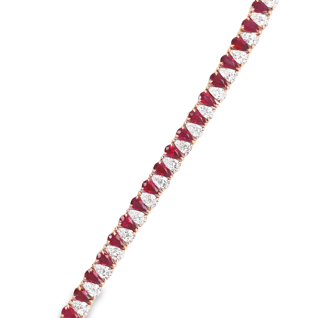 Stunning one of a kind bracelet  Smooth movement  Hidden clasp  18k rose gold  Pear shape rubies 6.41 cts   Pear shape diamond 6.27 cts   7" long 