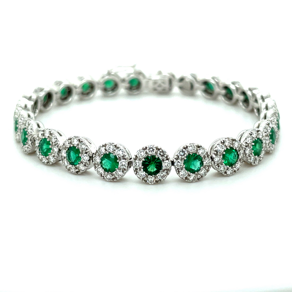 Diamond line bracelet  Set in 18k yellow gold  High quality diamonds 4.00 cts  Secure clasp with two figure eights  Round emerald 5.00 cts  7" long.
