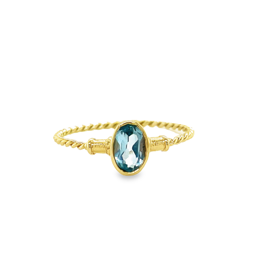 Luxuriate in this 14k yellow gold dainty oval blue topaz ring! Size 7.5, with a stunning 7.00 mm topaz, it nestles in a beautiful rope style shank.