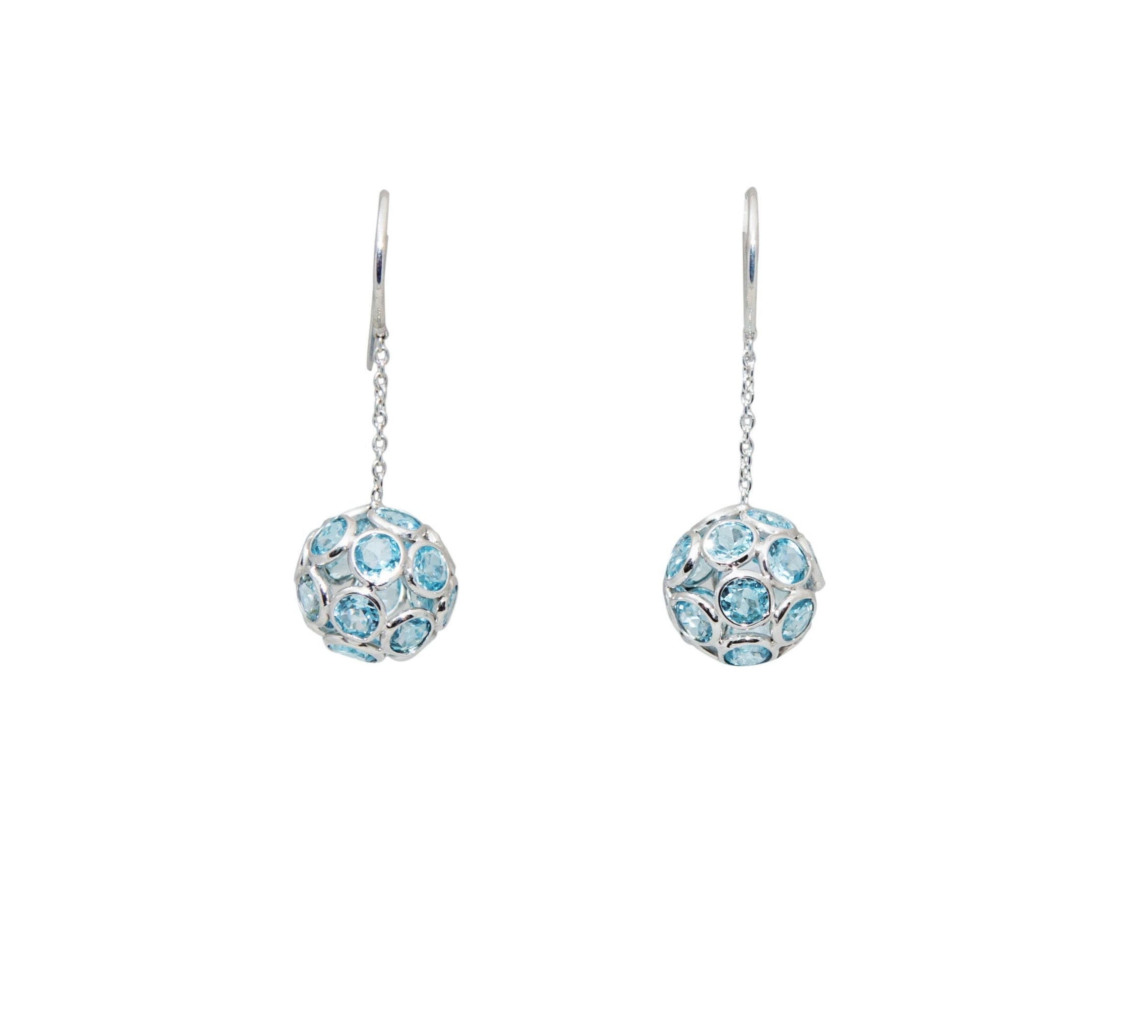 Indulge in the elegance of these 18k White Gold Blue Topaz Drop Earrings. Featuring 9.9 carats of brilliant blue topaz stones, these dangling ball earrings are set in luxurious 18k white gold and measure 1.5 inches in length. Elevate any look with these exquisite and exclusive earrings.