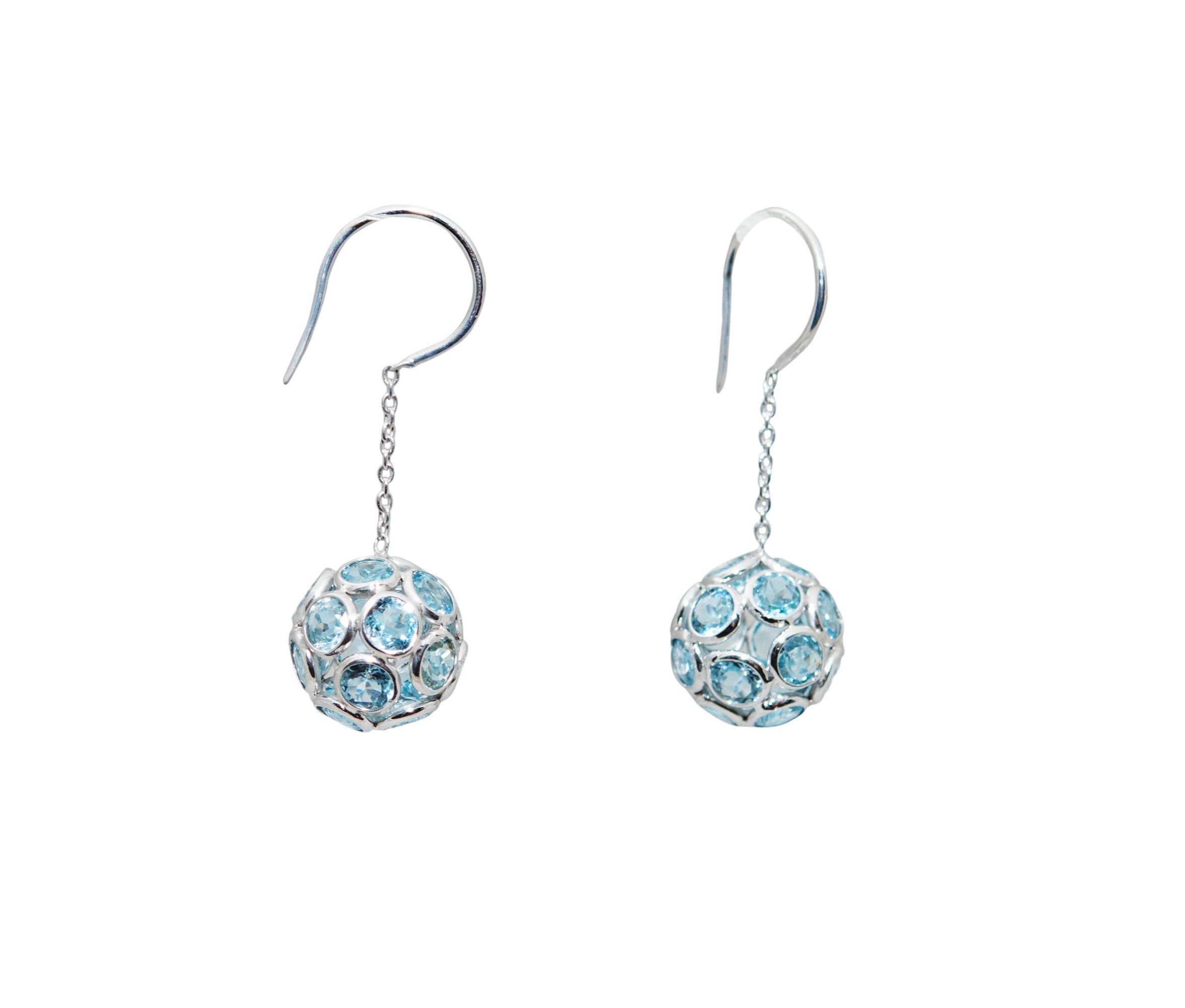 Indulge in the elegance of these 18k White Gold Blue Topaz Drop Earrings. Featuring 9.9 carats of brilliant blue topaz stones, these dangling ball earrings are set in luxurious 18k white gold and measure 1.5 inches in length. Elevate any look with these exquisite and exclusive earrings.