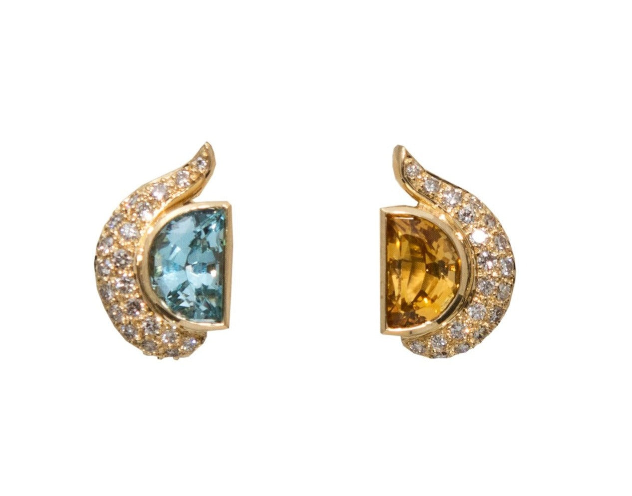 Crafted of dazzling 18k Yellow gold, this pair of earrings features 0.85 cts of diamonds, a half-moon shaped blue topaz, and a half-moon shaped citrine, all set in a 3/4" long, 1/2" wide mounting. Secured with an Omega clasp, these earrings are made in Italy.