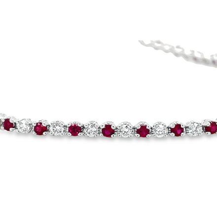 Ladies Line bracelet   Round cut diamonds 1.21 cts  Round rubies 1.31 cts   Color G-H  Clarity VS-1  All prong set  7" length  14kt white