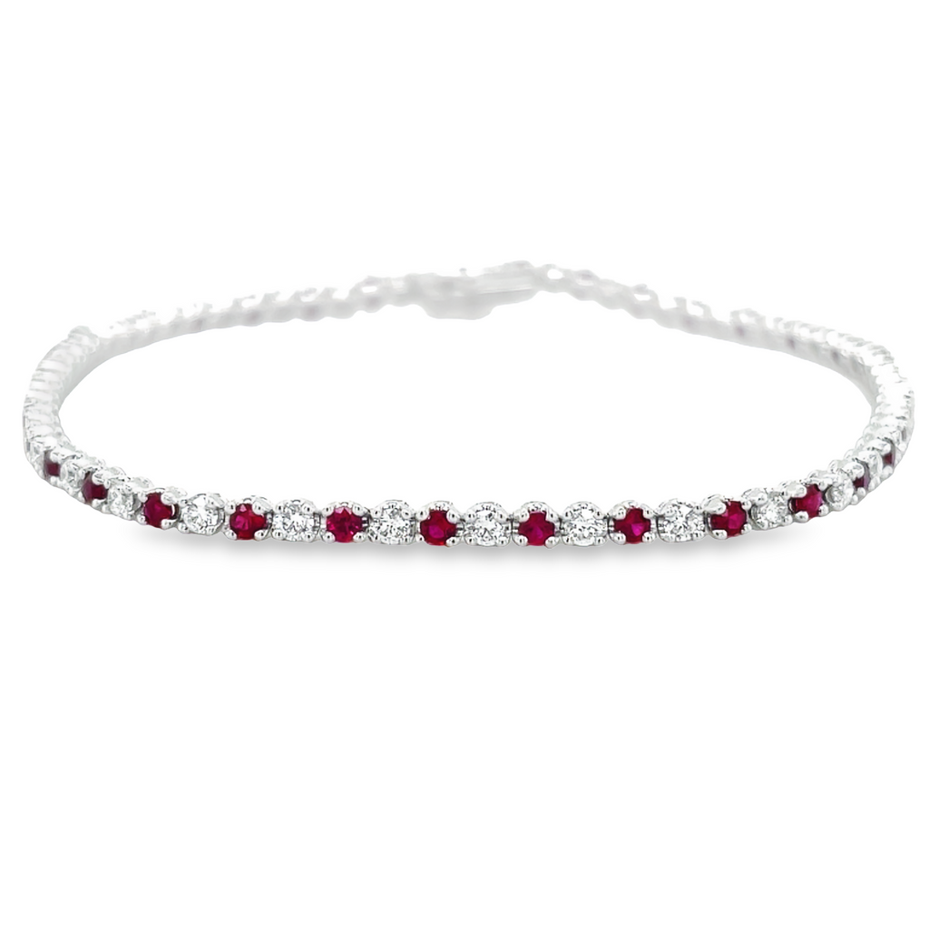 Ladies Line bracelet   Round cut diamonds 1.21 cts  Round rubies 1.31 cts   Color G-H  Clarity VS-1  All prong set  7" length  14kt white