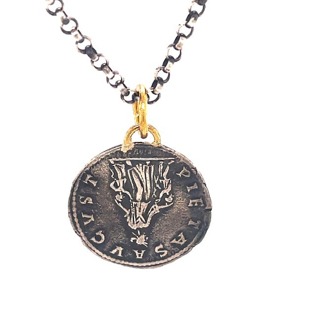 This exquisite piece features a classic 19.00mm round coin crafted from 24k gold with a matte finish and delicately detailed with a small round diamond. The optional necklace ($90) is handmade from the highest quality Turkish materials and includes an oxidized sterling silver chain with a secure lobster clasp closure. 
