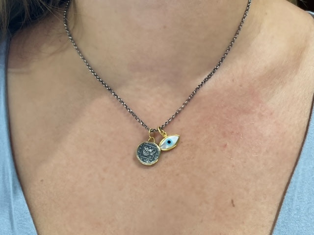 Featuring 15.00 mm of 24K gold, this handmade Turkish Pegasus pendant features a matte finish and a small round diamond. An optional oxidized sterling silver chain with a secure lobster catch is available for an additional $75. The chain measures 17" in length.