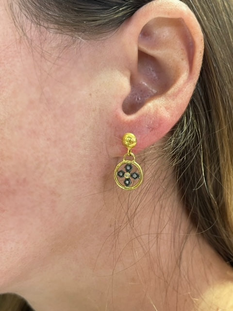 Circular coins with ornate Byzantine crosses adorn these earrings accompanied by petite round diamonds. Each piece is crafted by hand in Turkey with 24k gold and oxidized sterling silver, featuring a matte finish.