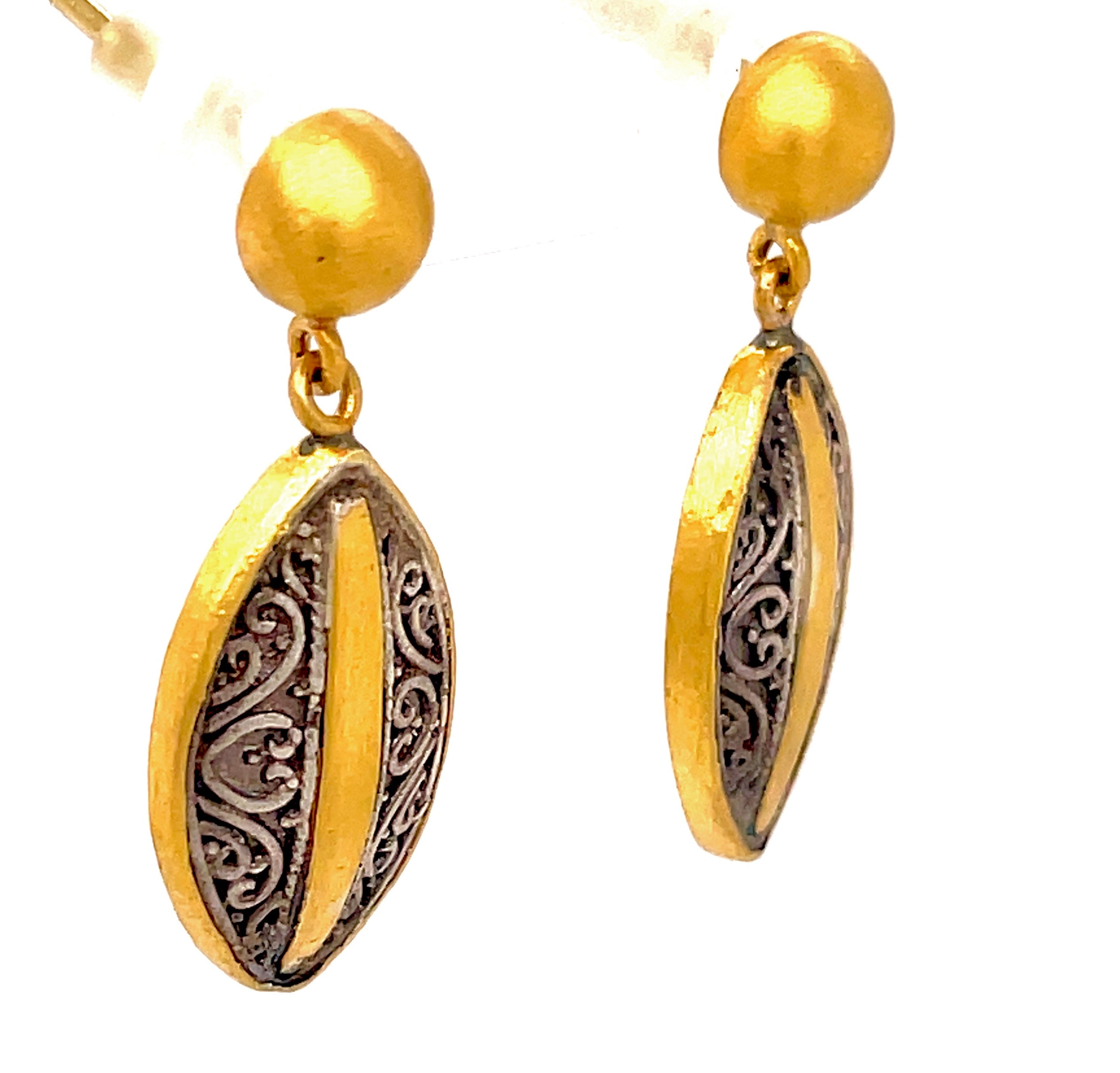 A unique combination of modern style, secure fit, and luxurious detail, these drop earrings are crafted with 24K gold and oxidized sterling silver for an eye-catching finish. Handmade in Turkey, this pair is sure to become a treasured addition to your collection.