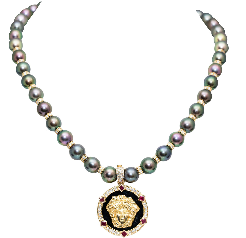 18k yellow gold Versace style charm with gallery finish at the back, set in onyx background, surrounded with diamonds 1.00 cts and 6 rubys 0.80 cts.- removable enhancer   27.00 mm charm size  8.00 mm enhancer bail 18k yellow gold with diamonds   Peacock pearls 8.81 mm with 20 yellow gold diamond rondels 2.00 cts and secure 18k yellow gold diamond catch   Items can be purchased separately   Pearl necklace 325-81 $4799.00  Charm 161-157 $3200.00  16" long.